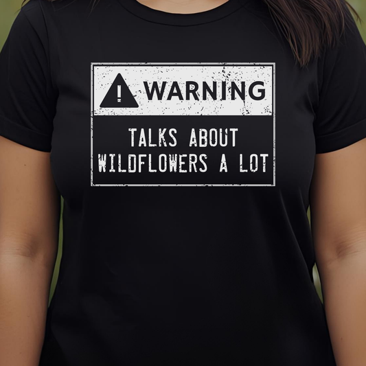 Black t-shirt with a warning sign graphic and text.