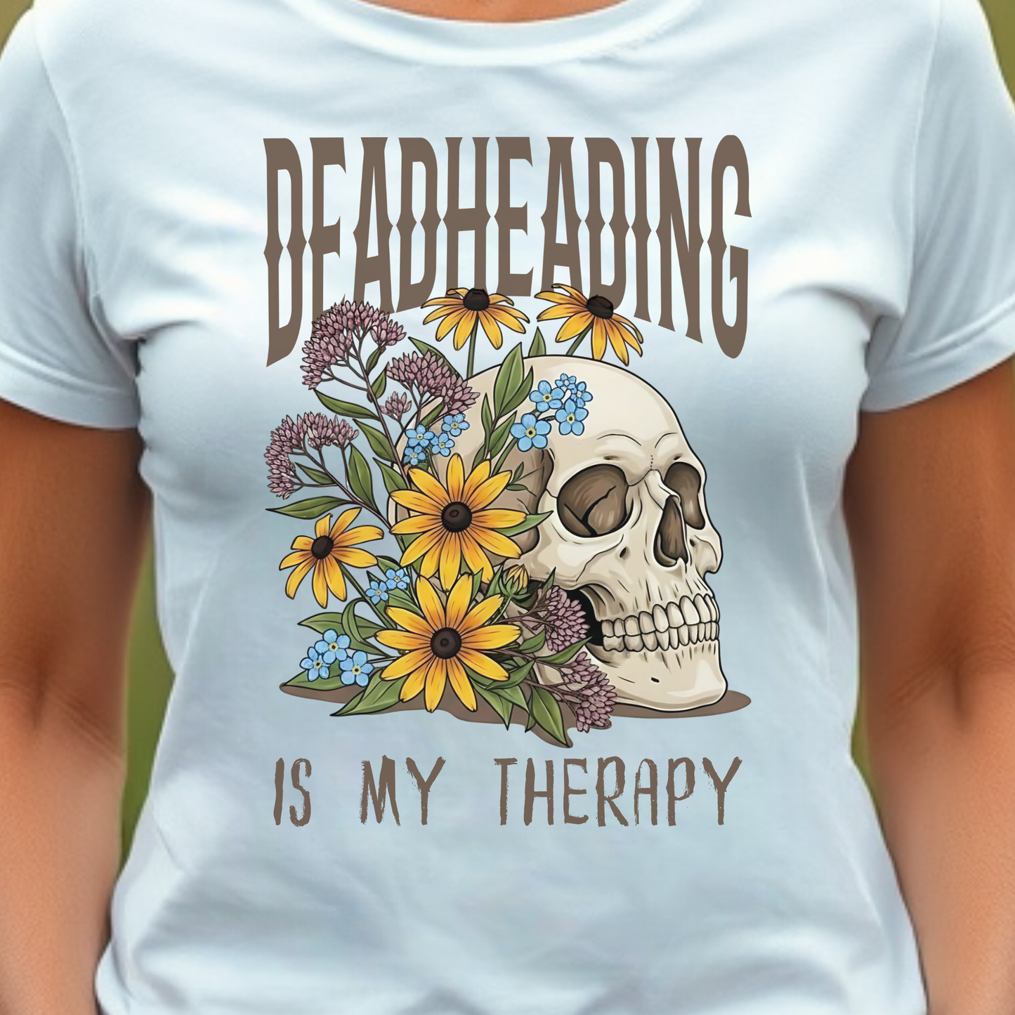 White t-shirt with a skull and flowers design and text 'DEADHEADING IS MY THERAPY'.