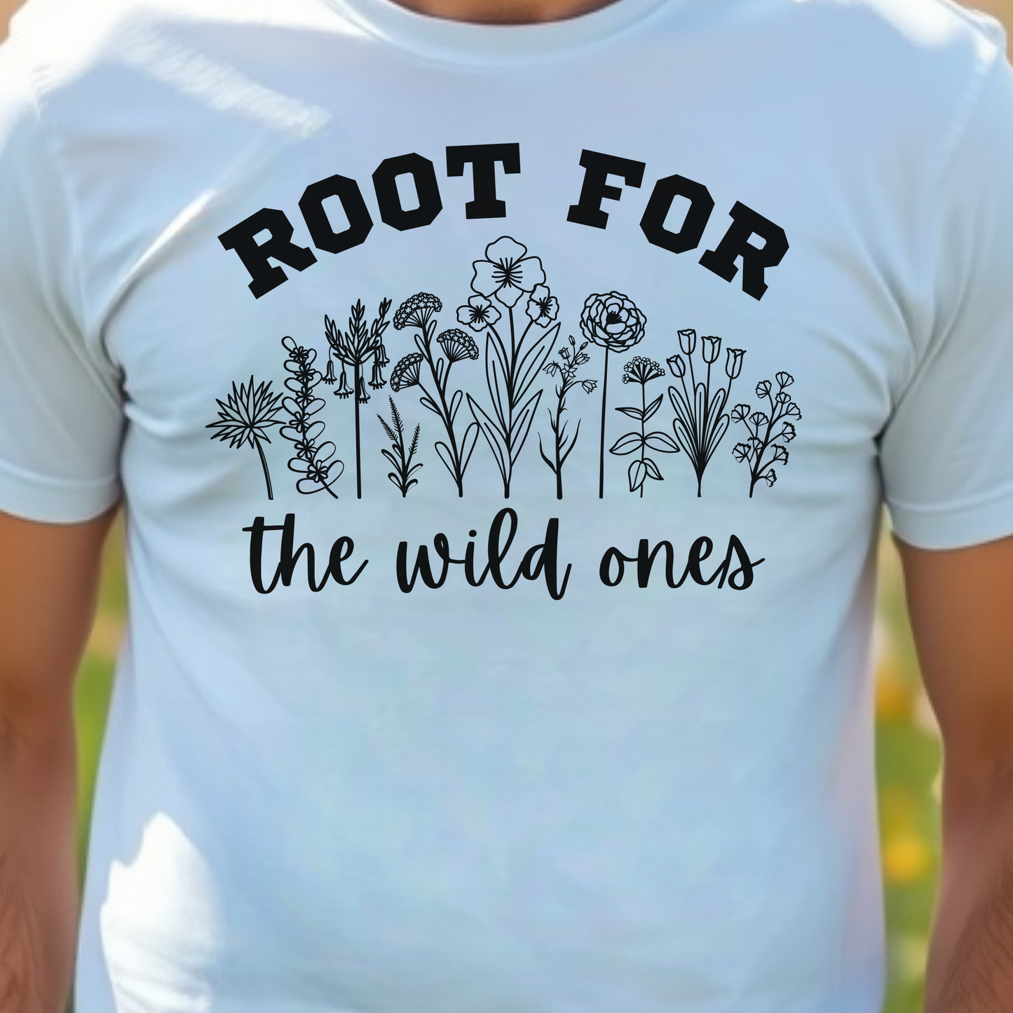 White t-shirt with text 'ROOT FOR the wild ones' and floral designs.