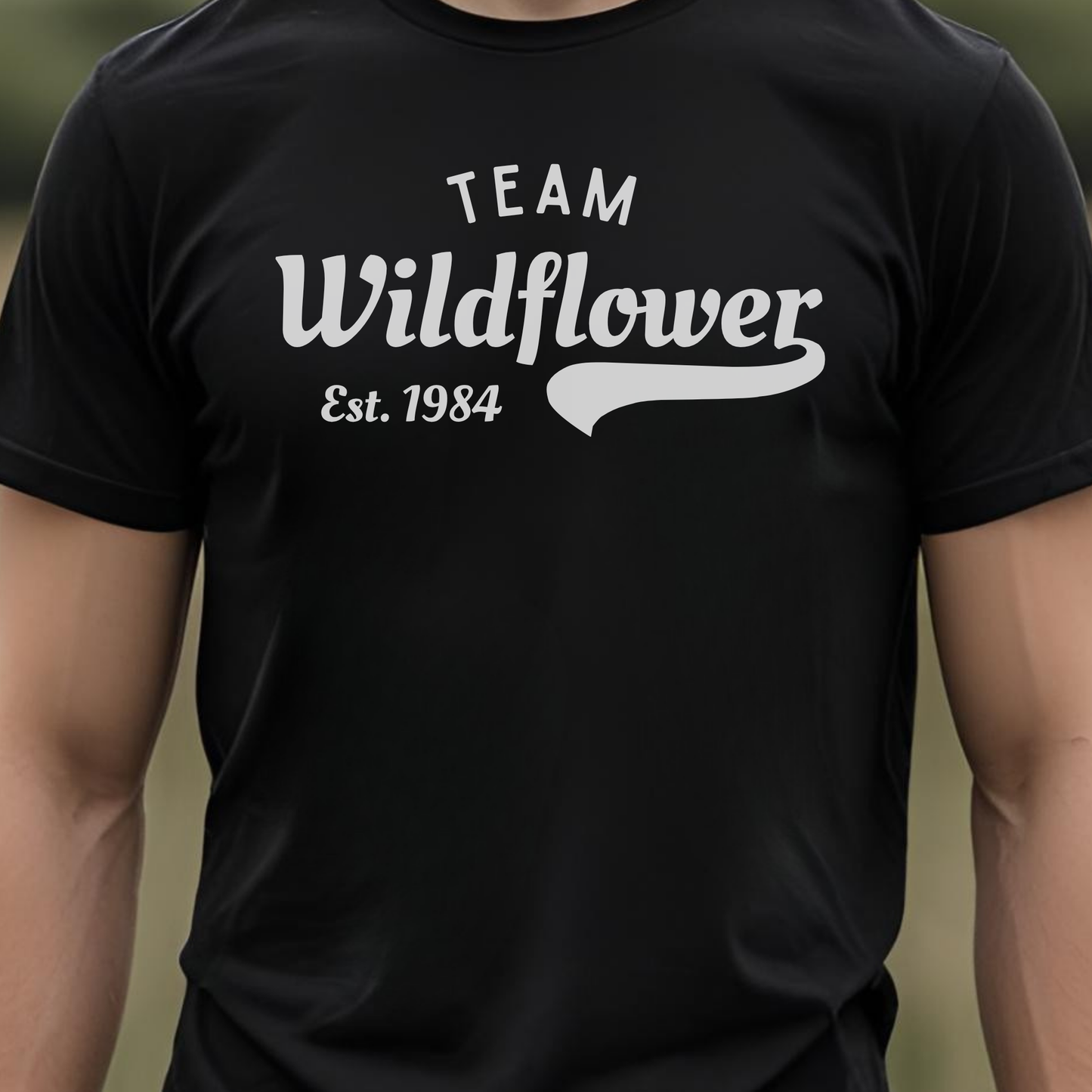 Black t-shirt with 'Team Wildflower Est. 1984' text.