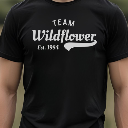 Black t-shirt with 'Team Wildflower Est. 1984' text.