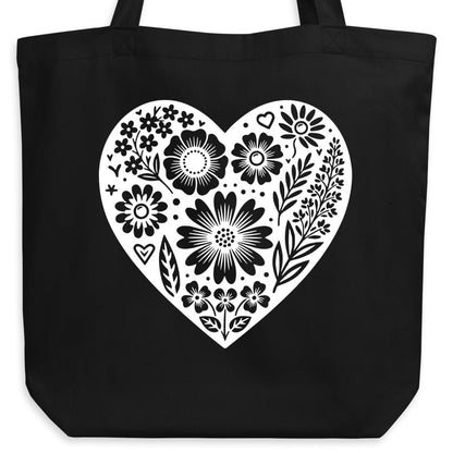 Black tote bag with a white floral heart design.
