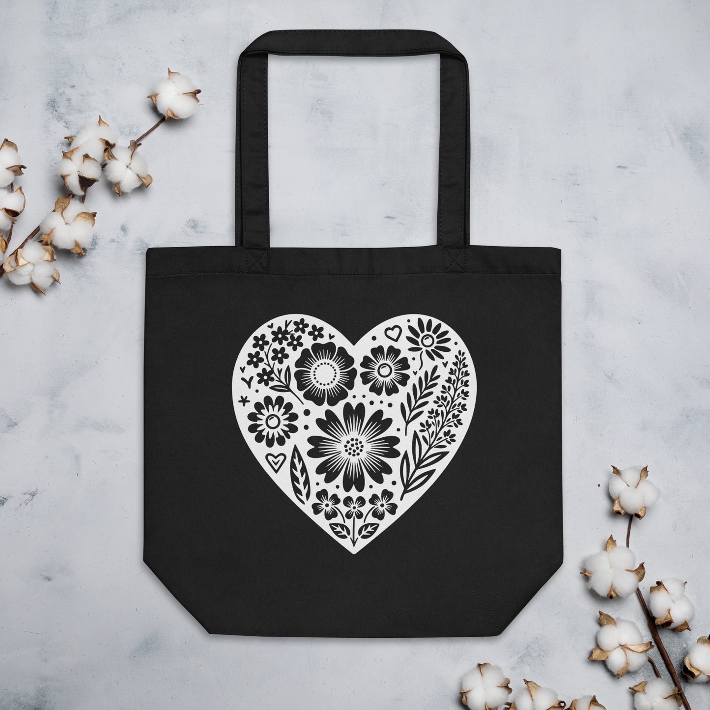 Black tote bag with floral heart design.