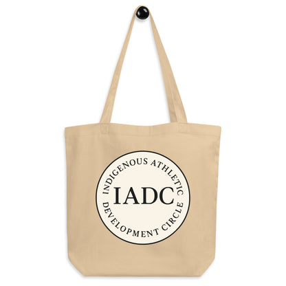 Beige tote bag with 'IADC' logo.