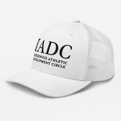 White cap with 'IADC Indigenous Athletic Development Circle' logo.