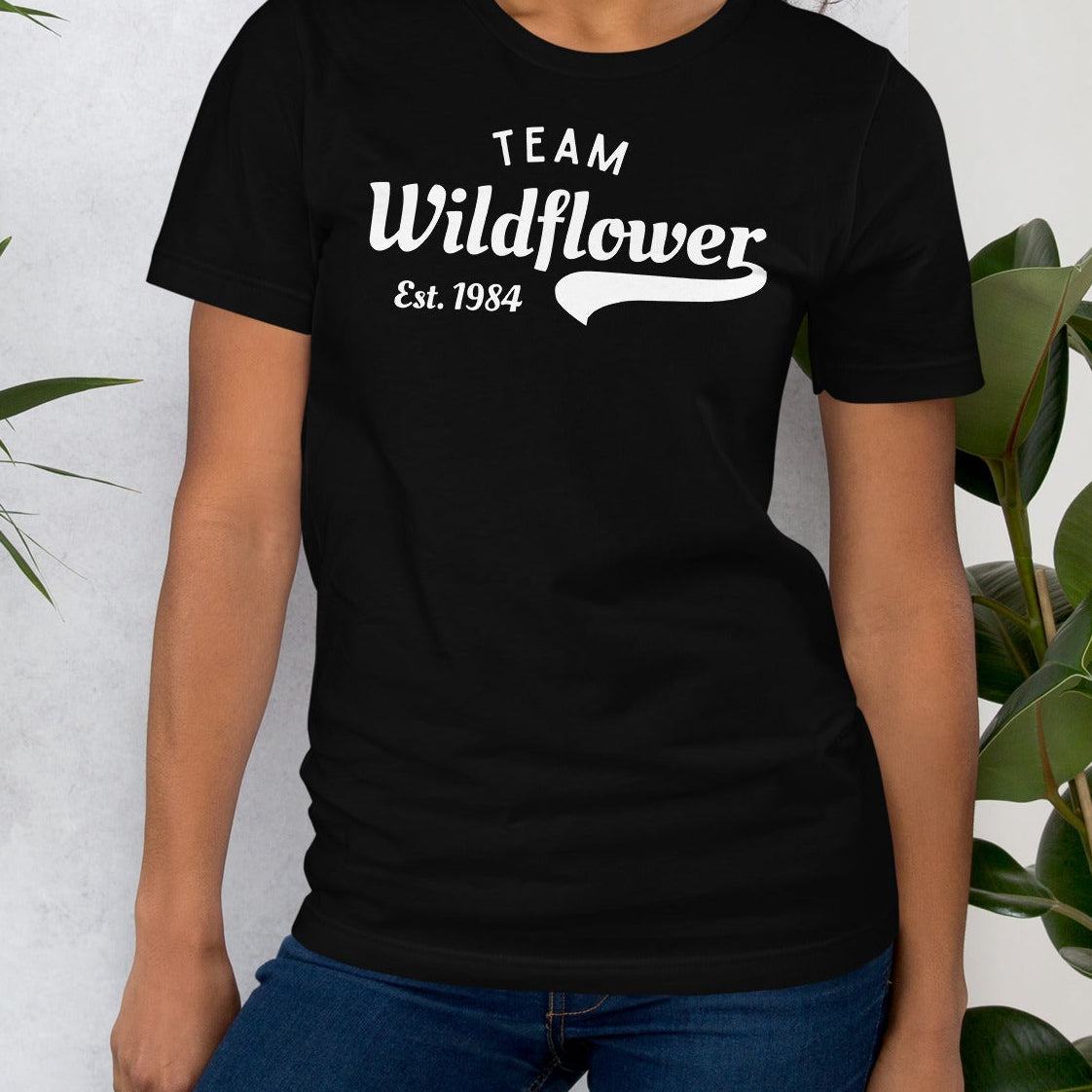 Black t-shirt with 'Team Wildflower Est. 1984' text.