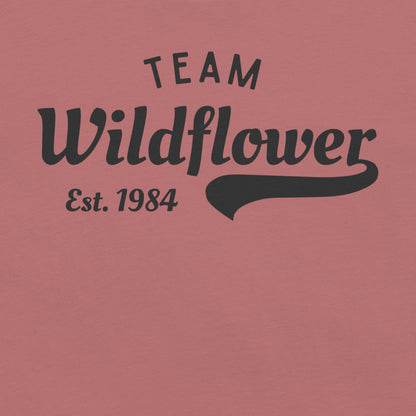 Mauve t-shirt with 'Team Wildflower Est. 1984' text.
