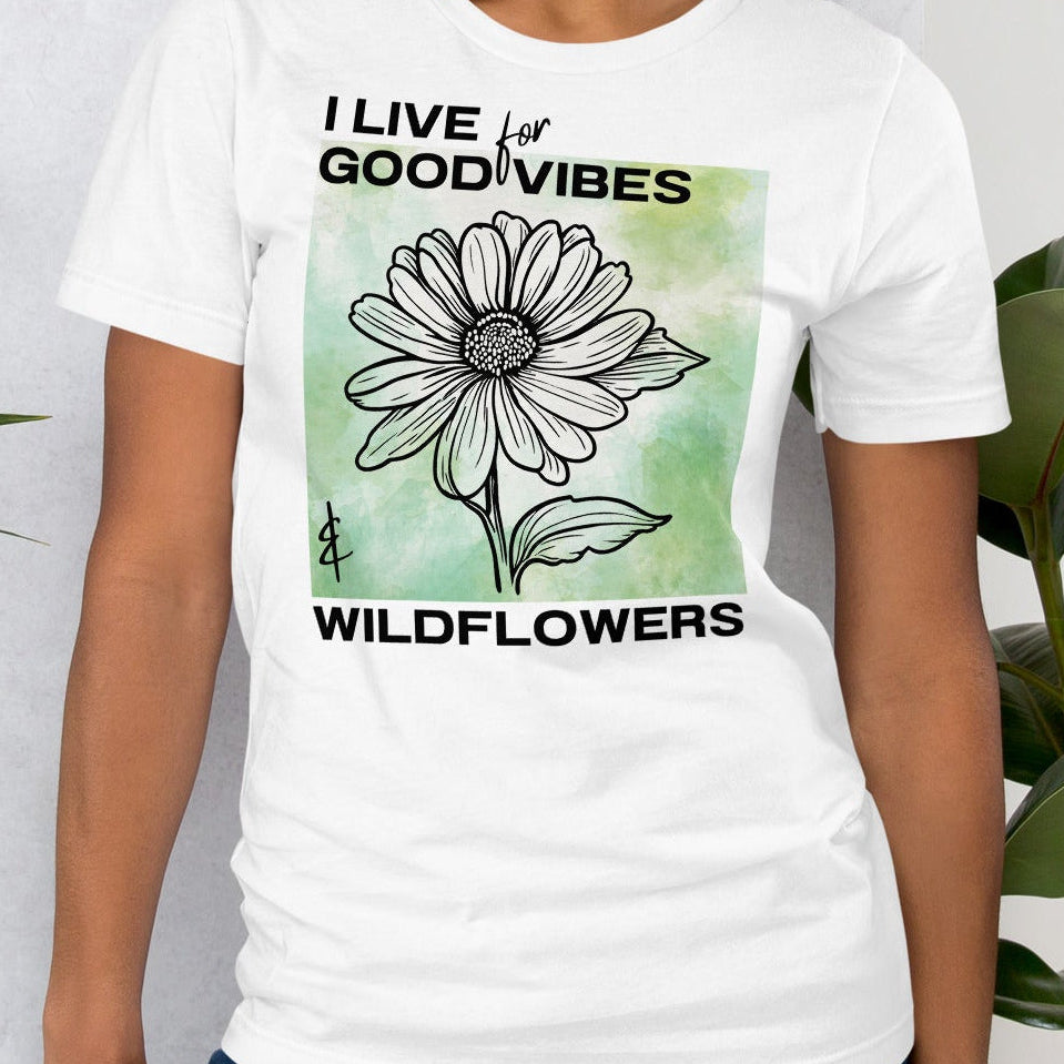White t-shirt with a flower design and text.