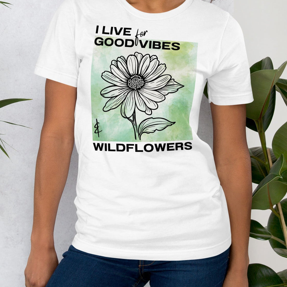 White t-shirt with a flower design and text.