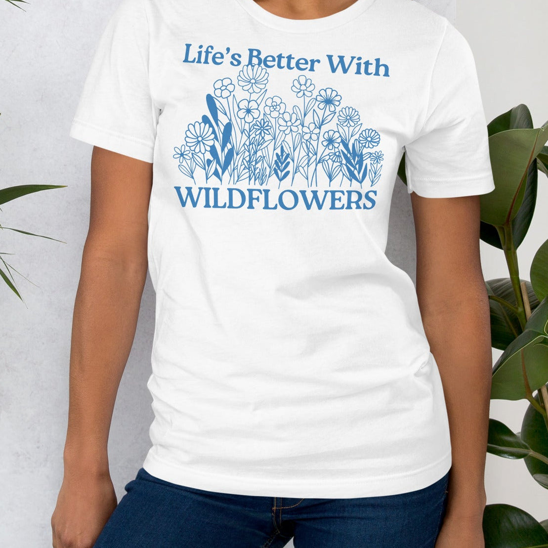 White t-shirt with text and floral design.